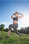 Close-up of a young woman exercising, stretching in a park in spring, Bavaria, Germany