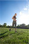 Young woman exercising, running in a park in spring, Bavaria, Germany