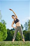 Close-up of a young woman doing sports in a park in spring