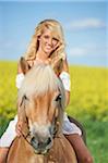 Young woman riding a haflinger horse in spring, Bavaria, Germany