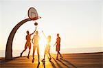 Group of friends playing basketball, outdoors