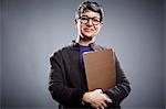 Studio portrait of mature businesswoman with clipboard