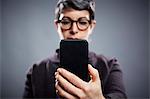 Studio portrait of mature businesswoman reading smartphone