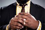 Close up studio portrait of mid adult businessman touching his wedding ring