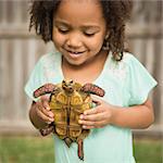 A child holding a tortoise.