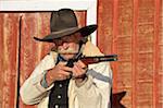 Portrait of Cowboy Aiming Rifle, Shell, Wyoming, USA