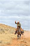 Cowboy Riding Horse with Lasso in Hand, Shell, Wyoming, USA