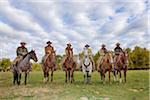 Cowboys and Cowgirls in a row Sitting on their Horses, Shell, Wyoming, USA