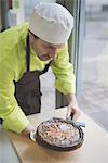 Waiter placing tart on table