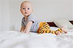 Portrait of baby girl crawling on bed