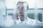 Male scientist scrutinizing test tube in lab