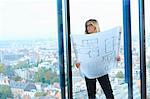 Mature architect in front of office window with Brussels cityscape, Belgium