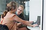 Woman and man chatting in office meeting