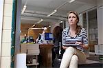 Young woman using digital tablet in office