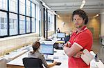 Portrait of man in busy creative office