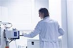 Female scientist in lab using scanning electron microscope