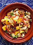 Still life with bowl of sweetcorn and mango salad