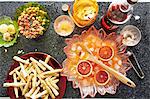 Still life of punch cocktail bowl with crisps and snacks