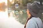 Young woman blowing bubbles