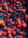 Still life with abundance of strawberries, blackberries, blueberries, raspberries and cranberries