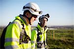 Two engineers at wind farm, walking together