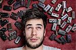 Young man with letterpress letters surrounding his head