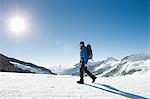 Man hiking in snow covered mountain landscape, Jungfrauchjoch, Grindelwald, Switzerland