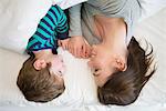 Mother and son relaxing together in bed, overhead view