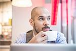 Businessman sitting in cafe drinking coffee