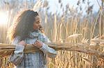 Woman carrying bundle of wheat