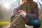 Man kneeling, rummaging in backpack