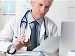 Doctor checking medical notes before prescribing drugs