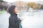 Portrait of young woman looking out from park at Lake Como, Italy