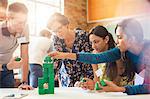 Creative business people stacking green blocks