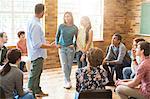 Man and women talking in group therapy session