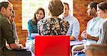 Woman leading group therapy session