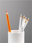 Orange pencil separated in cup with white pencils still life