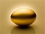 Golden egg on gold background still life