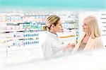 Pharmacist and customer talking in pharmacy