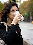 USA, New York, Manhattan, Greenwich Village, Young woman drinking coffee outdoors