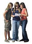 Three girls reading a letter smiling