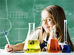 girl in a classroom with an erlenmeyer flask