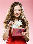 woman putting money in her purse