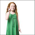 girl with curly red hair holding up one finger