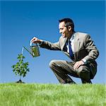 businessman with a watering can