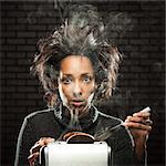 Studio shot of woman with smoking toaster