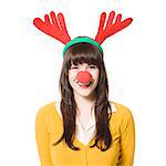 Studio shot of young woman wearing antlers and red nose