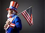 Studio portrait of Uncle Sam with american flag