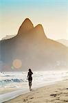 South America, Brazil, Rio de Janeiro, Ipanema, a young woman walking along the beach in the late afternoon MR