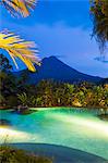 Costa Rica, Alajuela, La Fortuna. The Arenal volcano and swimming pool at The Springs Resort and Spa.